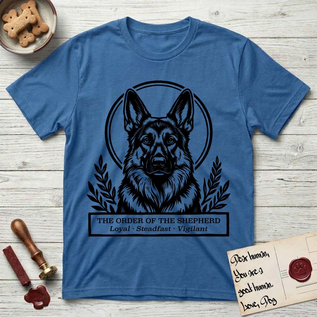 Holy Orders German Shepherd T-Shirt flat lay in Iris, featuring a bold black-and-white linocut saint-medallion portrait of a German Shepherd.