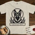 Holy Orders German Shepherd T-Shirt flat lay in Ivory, featuring a bold black-and-white linocut saint-medallion portrait of a German Shepherd.