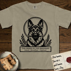 Holy Orders German Shepherd T-Shirt flat lay in Khaki, featuring a bold black-and-white linocut saint-medallion portrait of a German Shepherd.
