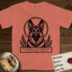 Holy Orders German Shepherd T-Shirt flat lay in Terracotta, featuring a bold black-and-white linocut saint-medallion portrait of a German Shepherd.