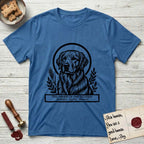 Holy Orders Golden Retriever T-Shirt flat lay in Iris, featuring a bold black-and-white linocut saint-medallion portrait of a Golden Retriever.