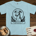 Holy Orders Greyhound T-Shirt flat lay in Chambray, featuring a bold black-and-white linocut saint-medallion portrait of a Greyhound.