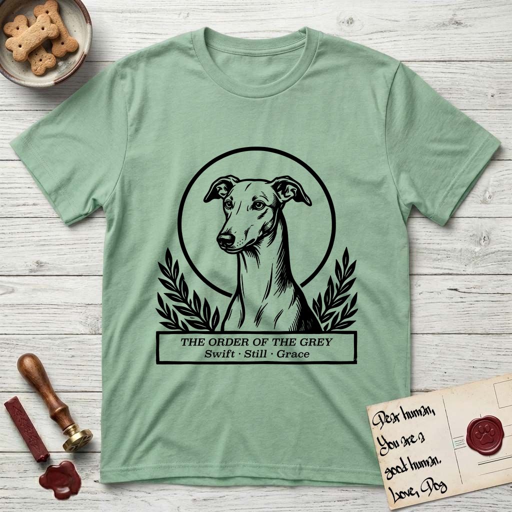 Holy Orders Greyhound T-Shirt flat lay in Mint Green, featuring a bold black-and-white linocut saint-medallion portrait of a Greyhound.