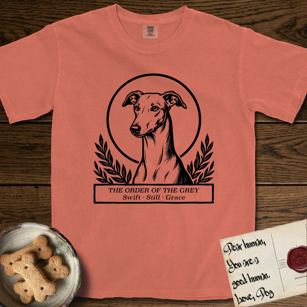 Holy Orders Greyhound T-Shirt flat lay in Terracotta, featuring a bold black-and-white linocut saint-medallion portrait of a Greyhound.