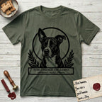 Holy Orders Lobo T-Shirt flat lay in Heather Military Green, featuring a bold black-and-white linocut saint-medallion portrait of Lobo, an Australian Cattle Dog and Pitbull mix with a white facial blaze.