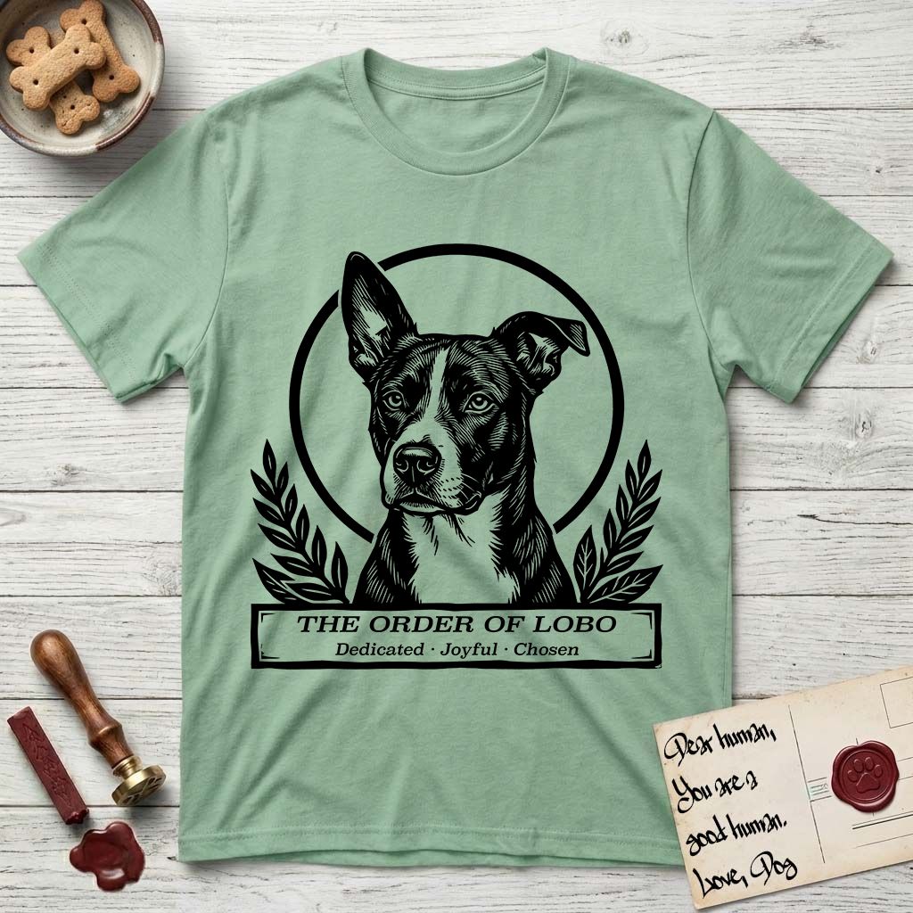 Holy Orders Lobo T-Shirt flat lay in Mint Green, featuring a bold black-and-white linocut saint-medallion portrait of Lobo, an Australian Cattle Dog and Pitbull mix with a white facial blaze.