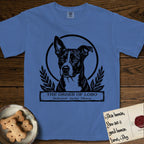 Holy Orders Lobo T-Shirt flat lay in Mystic Blue, featuring a bold black-and-white linocut saint-medallion portrait of Lobo, an Australian Cattle Dog and Pitbull mix with a white facial blaze.