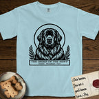 Holy Orders Newfoundland T-Shirt flat lay in Chambray, featuring a bold black-and-white linocut saint-medallion portrait of a Newfoundland.