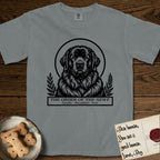 Holy Orders Newfoundland T-Shirt flat lay in Granite, featuring a bold black-and-white linocut saint-medallion portrait of a Newfoundland.