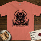 Holy Orders Newfoundland T-Shirt flat lay in Terracotta, featuring a bold black-and-white linocut saint-medallion portrait of a Newfoundland.