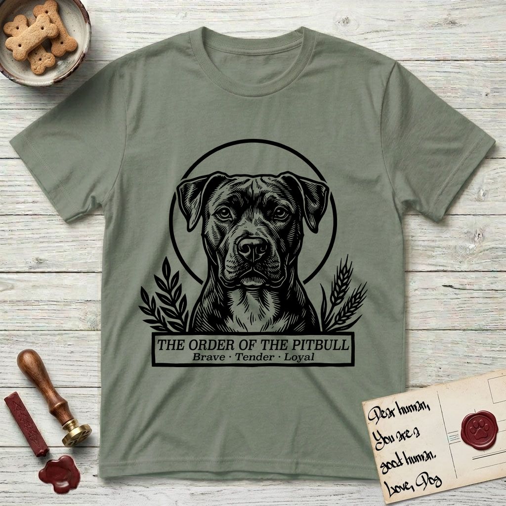 Holy Orders Pitbull T-Shirt flat lay in Sage, featuring a bold black-and-white linocut saint-medallion portrait of a Pitbull.