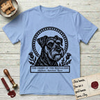Holy Orders Schnauzer T-Shirt flat lay in Light Blue, featuring a bold black-and-white linocut saint-medallion portrait of a Schnauzer.