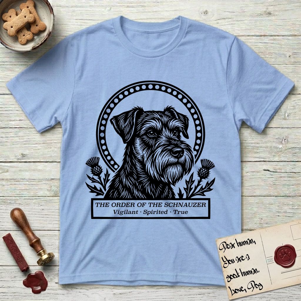 Holy Orders Schnauzer T-Shirt flat lay in Light Blue, featuring a bold black-and-white linocut saint-medallion portrait of a Schnauzer.