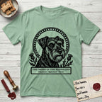 Holy Orders Schnauzer T-Shirt flat lay in Mint Green, featuring a bold black-and-white linocut saint-medallion portrait of a Schnauzer.