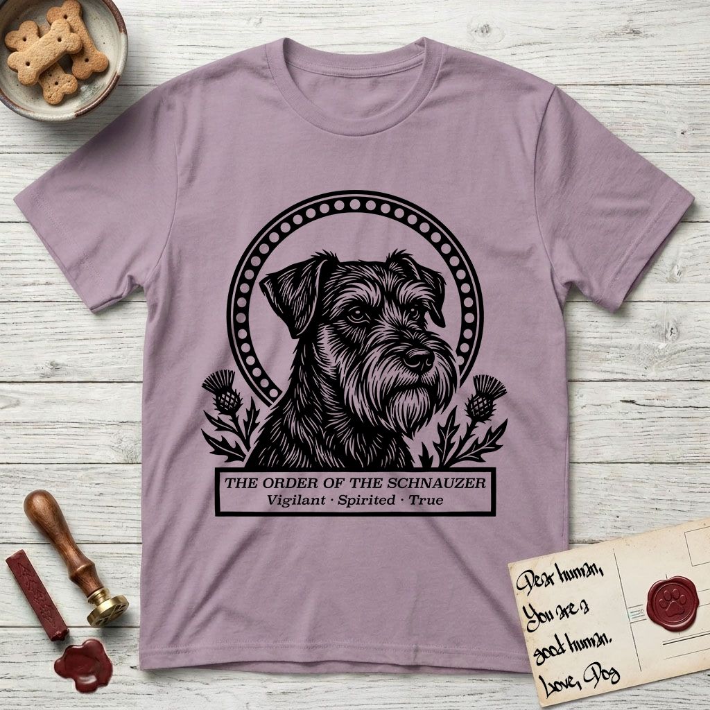 Holy Orders Schnauzer T-Shirt flat lay in Paragon, featuring a bold black-and-white linocut saint-medallion portrait of a Schnauzer.