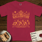 Hallowtide Australian Shepherd T-Shirt flat lay in Chili, featuring Orange one-color gothic illustration of three haloed merle Australian Shepherds walking in procession carrying a skeleton key, a scary jack-o'-lantern, and an iron lantern, under the blackletter headline HALLOWTIDE.