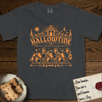 Hallowtide Australian Shepherd T-Shirt flat lay in Graphite, featuring Orange one-color gothic illustration of three haloed merle Australian Shepherds walking in procession carrying a skeleton key, a scary jack-o'-lantern, and an iron lantern, under the blackletter headline HALLOWTIDE.