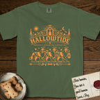 Hallowtide Australian Shepherd T-Shirt flat lay in Moss, featuring Orange one-color gothic illustration of three haloed merle Australian Shepherds walking in procession carrying a skeleton key, a scary jack-o'-lantern, and an iron lantern, under the blackletter headline HALLOWTIDE.