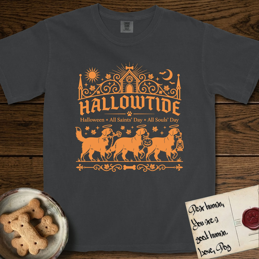 Hallowtide Bernese Mountain Dog T-Shirt flat lay in Graphite, featuring Orange one-color gothic illustration of three haloed Bernese Mountain Dogs walking in procession carrying a skeleton key, a scary jack-o'-lantern, and an iron lantern, under the blackletter headline HALLOWTIDE.