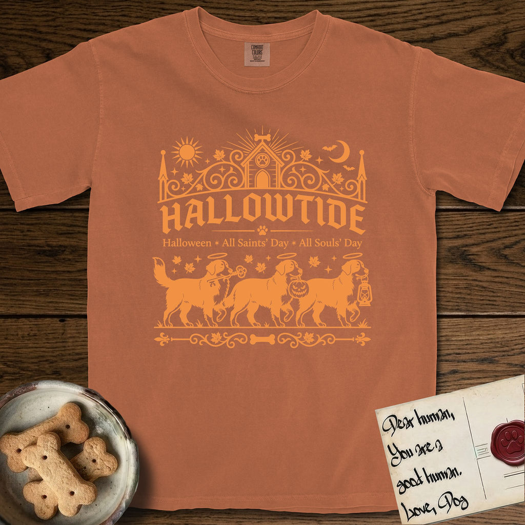 Hallowtide Bernese Mountain Dog T-Shirt flat lay in Yam, featuring Orange one-color gothic illustration of three haloed Bernese Mountain Dogs walking in procession carrying a skeleton key, a scary jack-o'-lantern, and an iron lantern, under the blackletter headline HALLOWTIDE.