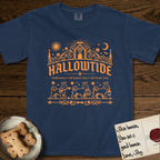 Hallowtide Maltese T-Shirt flat lay in True Navy, featuring Orange one-color gothic illustration of three haloed Maltese walking in procession carrying a skeleton key, a scary jack-o'-lantern, and an iron lantern, under the blackletter headline HALLOWTIDE.