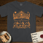 Hallowtide Pug T-Shirt flat lay in Graphite, featuring Orange one-color gothic illustration of three haloed curly-tailed Pugs walking in procession carrying a skeleton key, a scary jack-o'-lantern, and an iron lantern, under the blackletter headline HALLOWTIDE.