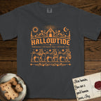 Hallowtide Shar-Pei T-Shirt flat lay in Graphite, featuring Orange one-color gothic illustration of three haloed wrinkled Shar-Peis walking in procession carrying a skeleton key, a scary jack-o'-lantern, and an iron lantern, under the blackletter headline HALLOWTIDE.