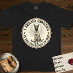 I Stand Amazed in the Presence Belgian Malinois T-Shirt flat lay in Black, featuring a vintage engraving medallion of a haloed Belgian Malinois with a small devoted human gazing up from below.