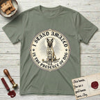 I Stand Amazed in the Presence Belgian Malinois T-Shirt flat lay in Sage, featuring a vintage engraving medallion of a haloed Belgian Malinois with a small devoted human gazing up from below.