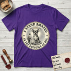 I Stand Amazed in the Presence Chihuahua T-Shirt flat lay in Purple, featuring a vintage engraving medallion of a haloed Chihuahua with a small devoted human gazing up from below.