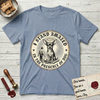 I Stand Amazed in the Presence Chihuahua T-Shirt flat lay in Stone Blue, featuring a vintage engraving medallion of a haloed Chihuahua with a small devoted human gazing up from below.