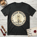 I Stand Amazed in the Presence Golden Retriever T-Shirt flat lay in Black, featuring a vintage engraving medallion of a haloed Golden Retriever with a small devoted human gazing up from below.