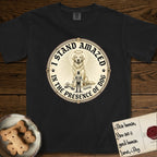 I Stand Amazed in the Presence Golden Retriever T-Shirt flat lay in Black, featuring a vintage engraving medallion of a haloed Golden Retriever with a small devoted human gazing up from below.
