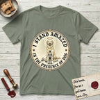 I Stand Amazed in the Presence Golden Retriever T-Shirt flat lay in Sage, featuring a vintage engraving medallion of a haloed Golden Retriever with a small devoted human gazing up from below.