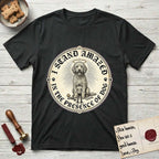 I Stand Amazed in the Presence Goldendoodle T-Shirt flat lay in Black, featuring a vintage engraving medallion of a haloed Goldendoodle with a small devoted human gazing up from below.