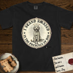 I Stand Amazed in the Presence Goldendoodle T-Shirt flat lay in Black, featuring a vintage engraving medallion of a haloed Goldendoodle with a small devoted human gazing up from below.