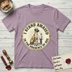I Stand Amazed in the Presence Great Dane T-Shirt flat lay in Paragon, featuring a vintage engraving medallion of a haloed Great Dane with a small devoted human gazing up from below.