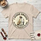 I Stand Amazed in the Presence Great Dane T-Shirt flat lay in Sand, featuring a vintage engraving medallion of a haloed Great Dane with a small devoted human gazing up from below.