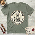 I Stand Amazed in the Presence Pitbull T-Shirt flat lay in Sage, featuring a vintage engraving medallion of a haloed Pitbull with a small devoted human gazing up from below.