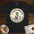 I Stand Amazed in the Presence Rescue Mutt T-Shirt flat lay in Black, featuring a vintage engraving medallion of a haloed rescue mutt with a small devoted human gazing up from below.