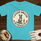 I Stand Amazed in the Presence Rescue Mutt T-Shirt flat lay in Lagoon Blue, featuring a vintage engraving medallion of a haloed rescue mutt with a small devoted human gazing up from below.
