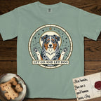 Let Go and Let Dog Australian Shepherd T-Shirt flat lay in Bay, featuring an antique celestial star chart with a haloed blue merle Australian Shepherd at the center, paws raised, stars scattered through her coat.