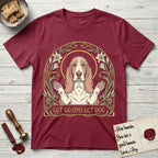 Let Go and Let Dog Basset Hound T-Shirt flat lay in Cardinal Red, featuring an Art Nouveau botanical illustration of a haloed Basset Hound with paws raised in blessing.