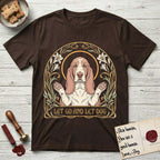 Let Go and Let Dog Basset Hound T-Shirt flat lay in Dark Chocolate, featuring an Art Nouveau botanical illustration of a haloed Basset Hound with paws raised in blessing.