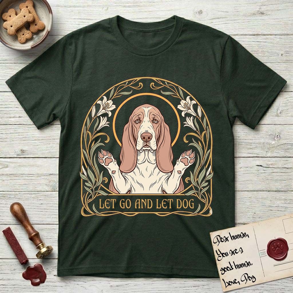 Let Go and Let Dog Basset Hound T-Shirt flat lay in Forest Green, featuring an Art Nouveau botanical illustration of a haloed Basset Hound with paws raised in blessing.