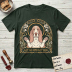 Let Go and Let Dog Basset Hound T-Shirt flat lay in Forest Green, featuring an Art Nouveau botanical illustration of a haloed Basset Hound with paws raised in blessing.