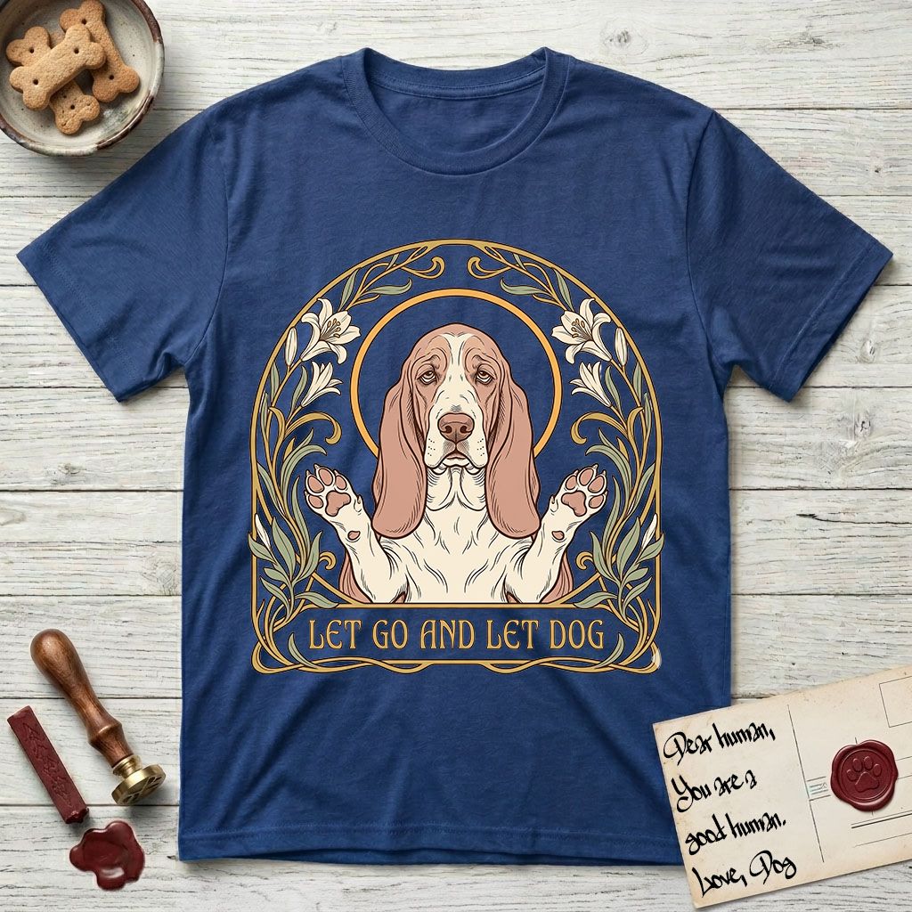 Let Go and Let Dog Basset Hound T-Shirt flat lay in Royal, featuring an Art Nouveau botanical illustration of a haloed Basset Hound with paws raised in blessing.