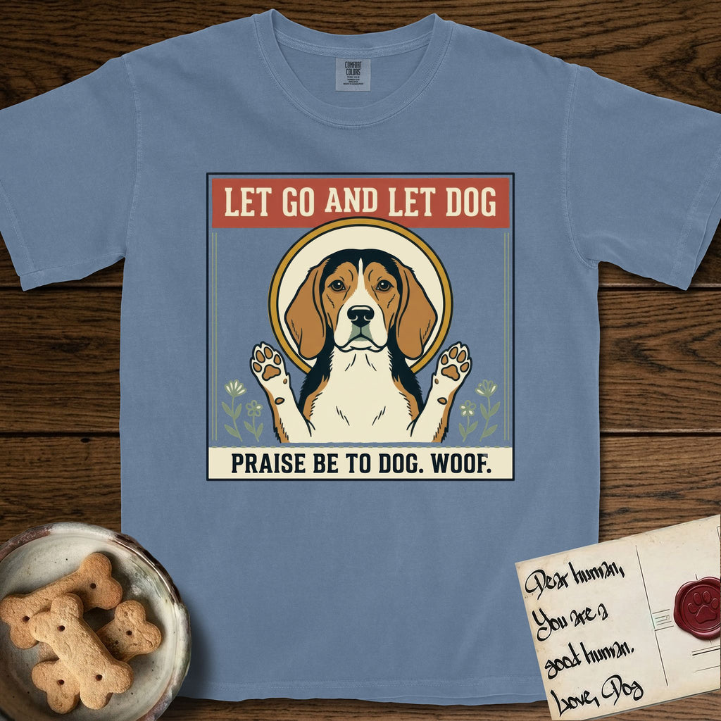 Let Go and Let Dog Beagle T-Shirt flat lay in Blue Jean, featuring a vintage seed packet label with a haloed tricolor Beagle, paws raised, flanked by simple flower sprigs.
