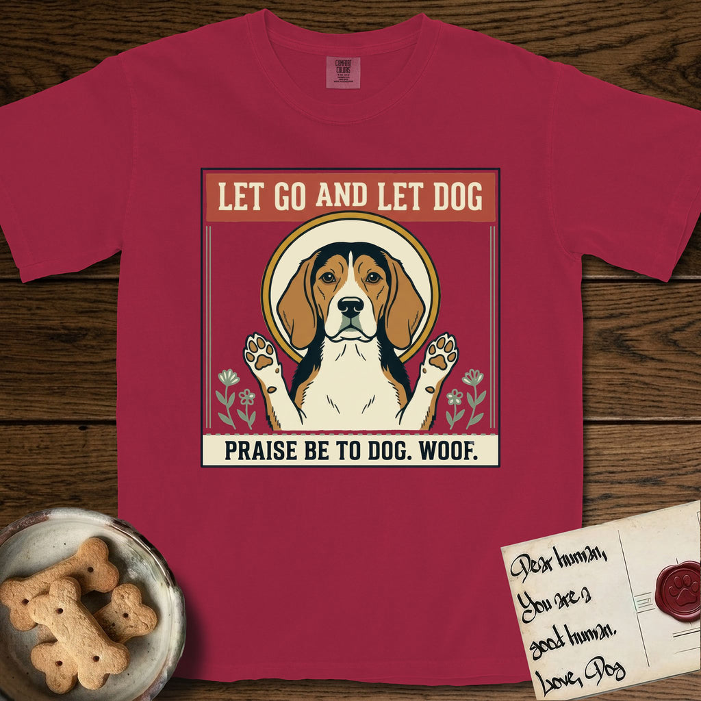 Let Go and Let Dog Beagle T-Shirt flat lay in Chili, featuring a vintage seed packet label with a haloed tricolor Beagle, paws raised, flanked by simple flower sprigs.