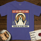 Let Go and Let Dog Beagle T-Shirt flat lay in Grape, featuring a vintage seed packet label with a haloed tricolor Beagle, paws raised, flanked by simple flower sprigs.